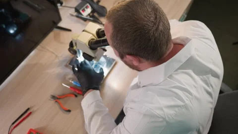 Top View of Technician in Lab Coat Working with Microscope in Laboratory Stock Footage 283121563