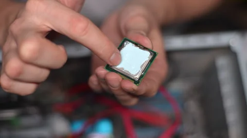 Top view of technician male applying and smearing new thermal paste to PC CPU Stock Footage 276545815