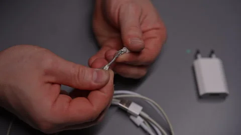 Top view of technician man carefully inspecting and examining damaged white USB Stock Footage 290927667