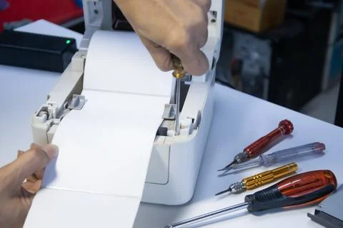 Top view. Technician repairing printer, label printer. Stock Photos