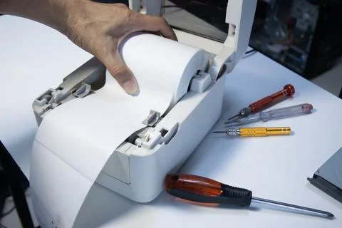 Top view. Technician repairing printer, label printer.. Stock Photos