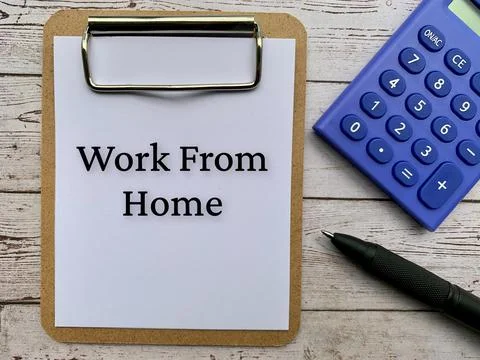 Top view of text on notepad - Work from home. With calculator, pen and wooden Stock Photos