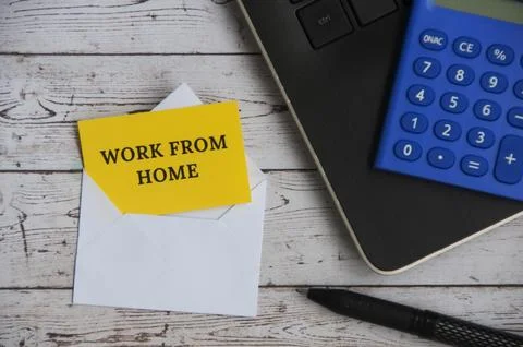 Top view of text - Work from home on notepad in an envelope with office set.. Stock Photos
