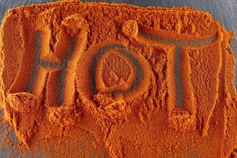 Top view on the texture background of red chilli pepper powder with text Stock Photos