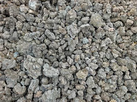 Top view texture of dark volcanic rock fragments and raw porous lava stones Fotos Stock
