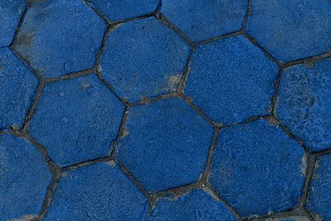 Top view on texture of hexagonal paving slabs covered with blue paint. Pavement 스톡 사진