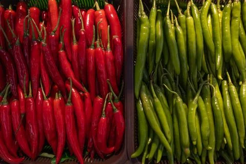 Top view texture of scattered red and green hot chili peppers, background. .. Stock Photos