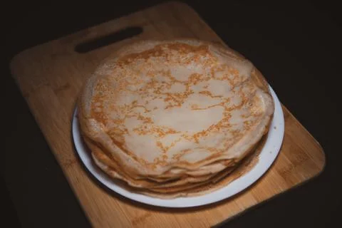 Top view of thin pancake on black background and copy space Stock Photos