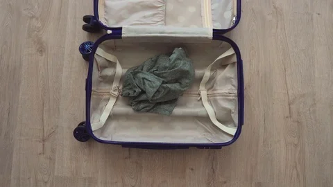 Top view, things fall into a suitcase. Stock Footage 117057471