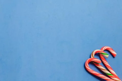 Top view three candy canes on blue background Stock Photos