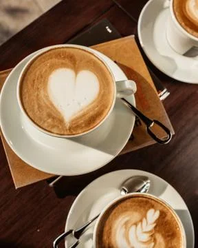 Top view of three cups of coffee with latte arts Stock Photos