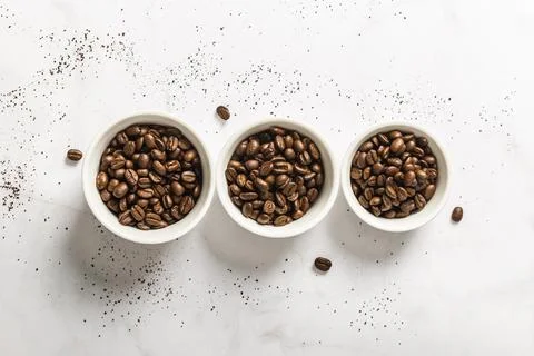 Top view three cups with roasted coffee beans Stock-Fotos