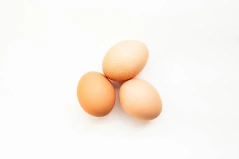 Top view of three eggs on white background Stock Photos