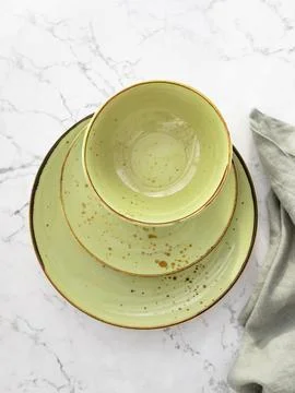 Top view of three empty green plates on white marble table. Pile of three blank Stock Photos