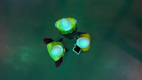 Top view three engineers and a director of a warehouse with a tablet Stock Footage 113091830