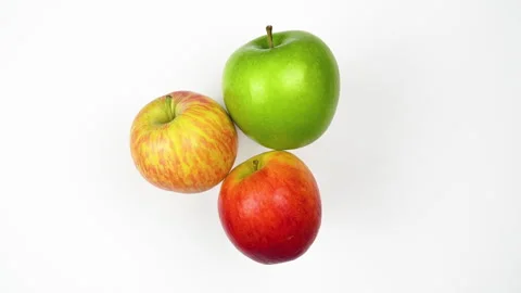 Top View Three Fresh Apples Green And Red Rotating On White Background 4K Stock Footage 321884069
