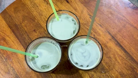 Top view of three fresh sugarcane juice on wooden table background Stock Footage 332912850