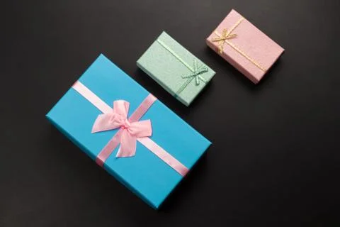 Top view three gift boxes on a black background ,holiday sales concept Stock Photos