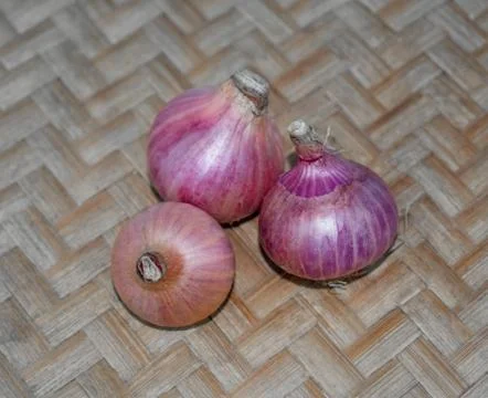 Top view of three medium sized red colored fresh onion gathered together on a Stock Photos