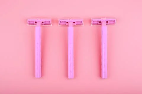 Top view of three plastic razors for shaving against pink background Stock Photos