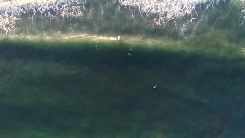 Top view of three surfers going into the sea on their surfboards in search .. Stock-Footage 270560204