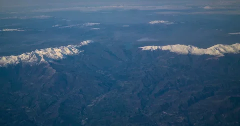 Top view through the plane of mountain ranges with little snow Video stock 272579859