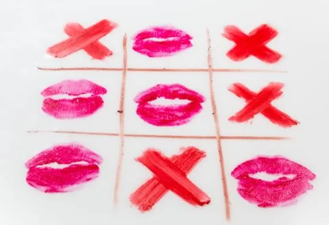 Top view of tic-tac-toe with black crosses and lips prints Stock Photos
