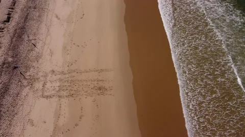 Top view &amp; tilt empty beach são João with Caparica in background, Portugal 4K Video stock 154457941