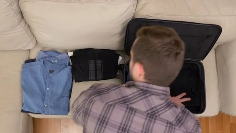 Top view timelapse of man packing clothes into a suitcase Stock Footage 74087173