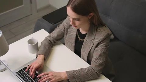 Top view. Tired upset young woman using laptop looking at screen typing message 스톡 동영상 150398912