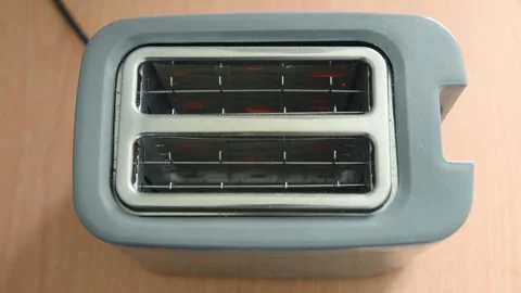 Top view toaster heating elements glowing red on wooden surface in sequence Stock Footage 334570255