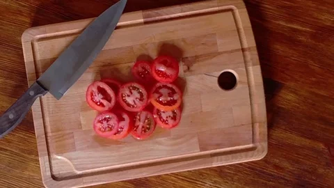 Top view of tomato slices, rotation of tomato slices on wooden board, hd video Stock Footage 73711244