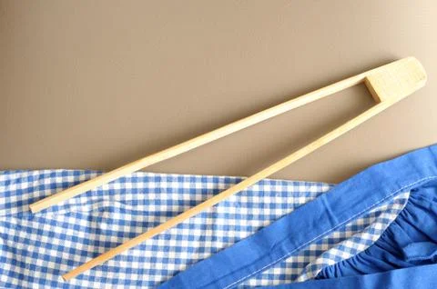Top view of a tong on a checkere blue cloth Stock Photos