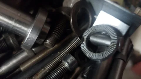 Top view of a toolbox filled with various industrial bolts, screws, and nuts Vídeos de archivo 335826663