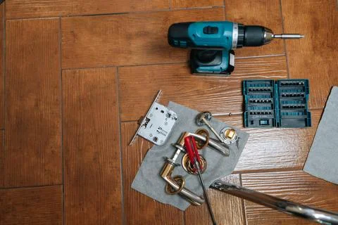 Top view of tools and hardware for door lock installation or repair project Stock Photos
