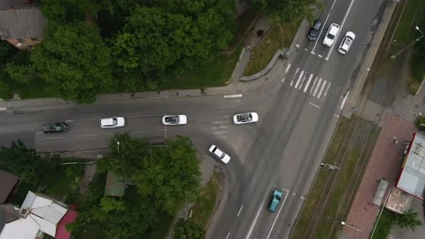 Top view tracking from a height of a cortege of white cars traveling on the road Stock Footage 179922700