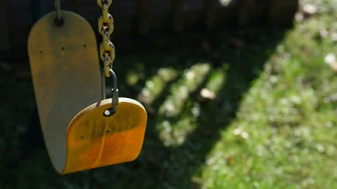 Top view tracking of lonely old weathered yellow swing child playset outdoor Video stock 95032926