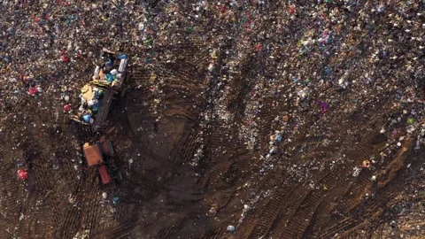 Top view of tractor dumps garbage on the landfill. Stock Footage 245266137