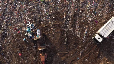 Top view of tractor dumps garbage on the landfill. Stock Footage 245267480