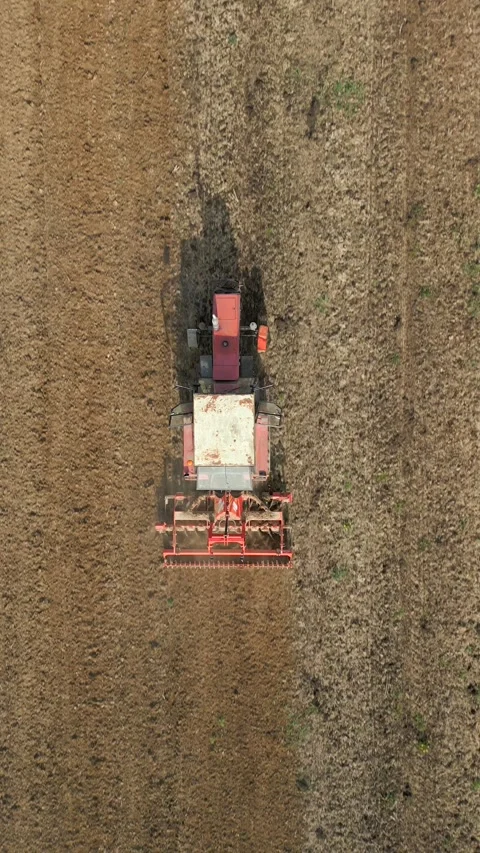 Top View Of Tractor Harrowing Soil In Agricultural Field. Stockbeeldmateriaal 273167208