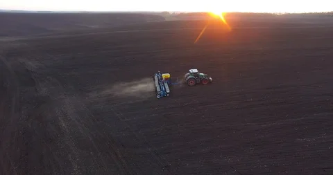 Top view of a tractor planting wheat at sunset Stock Footage 88705123