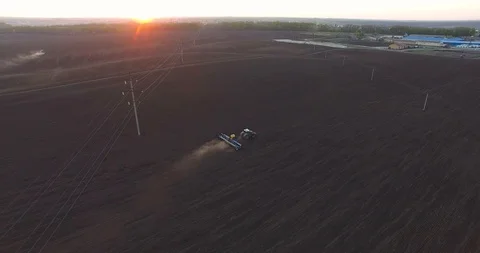 Top view of a tractor planting wheat at sunset Stockbeeldmateriaal 88706109