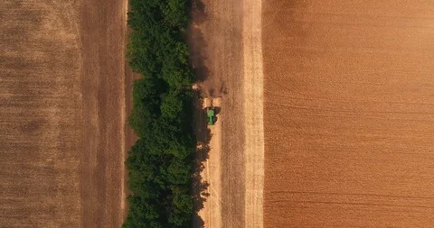 Top view of the tractor ploughing up the field after gathering in wheat Stock Footage 109296988