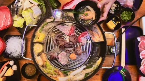 Top view of traditional Thai BBQ hotpot (Moo Krata) with mixed seafood, oct.. Stock-Footage 318543165