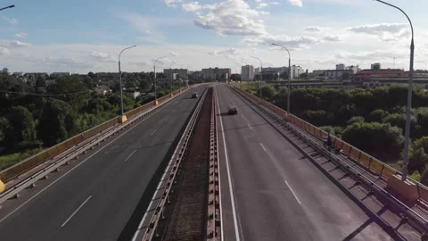 Top view of traffic on the bridge across the river among the green shore on a Stock-Footage 150814888
