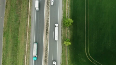 Top view on the traffic on highway between green fields. Stock Footage 154911840