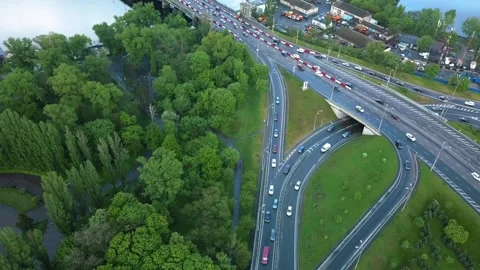 Top view of a traffic intersection that turns into a bridge over the river after Stock-Footage 154569305