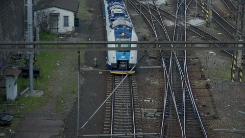 Top view of the train station, a modern train drives along the train tracks 스톡 동영상 115319437