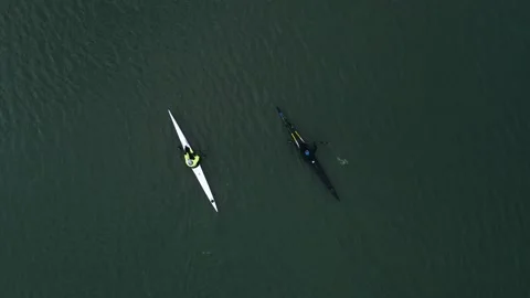 Top view of training of two men on kayaks floating on river water at sunny day Stock Footage 142889132