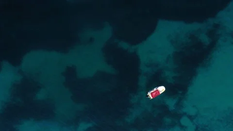 Top view tranquility sea stranded with small water transport aerial static shot Stock Footage 107782361